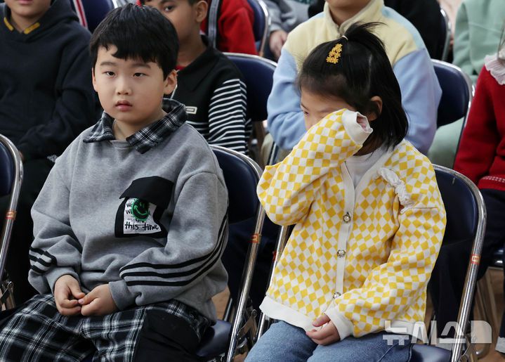 [부산=뉴시스] 하경민 기자 = 부산 사상구 괘법초등학교가 저출산, 학령인구 감소 등으로 인근 학교와 통·폐합이 확정된 가운데 20일 학교 강당에서 열린 이별식에 참석한 학생들이 눈물을 훔치고 있다.  1982년 3월5일 28학급(학생 1261명)으로 개교한 괘법초는 지난해 전교생 52명의 소규모 학교로 운영, 인근 감전초등학교와 통·폐합이 확정됐다. 괘법초를 비롯해 올해 부산에서 통·폐합되는 초등학교는 영도구 봉삼초 및 신선초 등 총 3곳이다. 2026.01.20. yulnetphoto@newsis.com