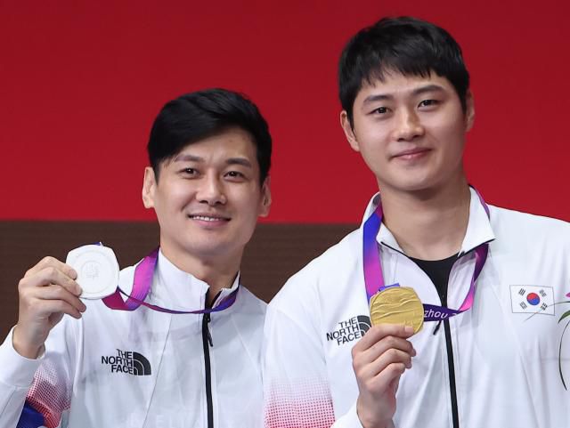 25일 중국 항저우 전자대학 체육관에서 열린 2022 항저우 아시안게임 펜싱 남자 사브르 개인전 메달 수여식에서 금메달을 획득한 오상욱과 은메달을 획득한 구본길이 메달을 보여주고 있다. 2023.9.25 [사진=연합뉴스]