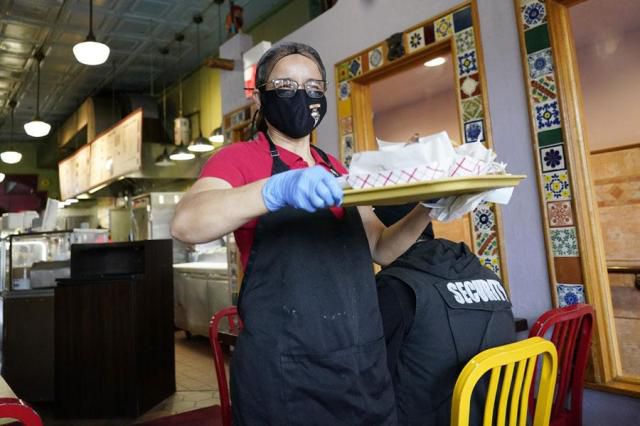 A waitress works at a restaurant in Chicago, in this file photo taken in March 2023. AP-Yonhap