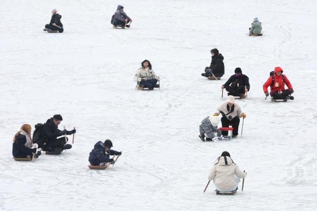 Visitors enjoy snow sled at the Hwacheon Sancheoneo Ice Festival in Hwacheon, Gangwon Province. Jan. 12, 2026. AJP Han Jun-gu