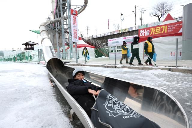 A visitor rides down a slide at the Hwacheon Sancheoneo Ice Festival in Hwacheon, Gangwon Province. Jan. 12, 2026. AJP Han Jun-gu