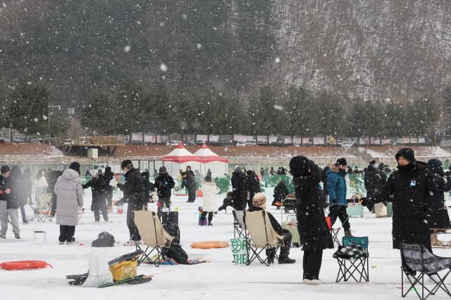 Visitors try ice fishing across the frozen ice field at the Hwacheon Sancheoneo Ice Festival in Hwacheon, Gangwon Province. Jan. 12, 2026. AJP Han Jun-gu