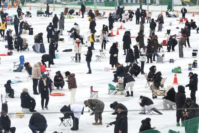 Visitors try ice fishing across the frozen ice field at the Hwacheon Sancheoneo Ice Festival in Hwacheon, Gangwon Province. Jan. 12, 2026. AJP Han Jun-gu