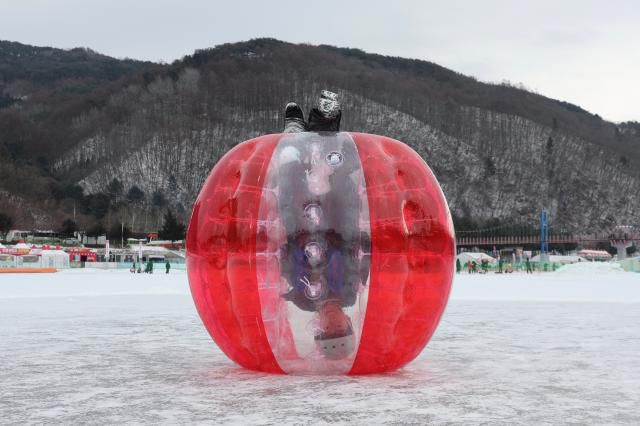 A child plays inside a bubble suit on the ice at the Hwacheon Sancheoneo Ice Festival in Hwacheon, Gangwon Province. Jan. 12, 2026. AJP Han Jun-gu