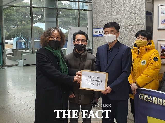 문성호 대전시민사회단체연대회의 공동대표(사진 왼쪽)이 배성근 부교육감에게 기자회견문을 전달하고 있다. / 대전 = 김성서 기자.