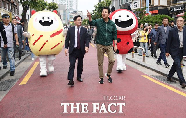 오세훈 서울시장(오른쪽)과 박강수 마포구청장이 13일 오후 서울 마포구 홍대 일대에서 열린 '레드로드 페스티벌'에 참석해 레드로드를 걷고 있다.