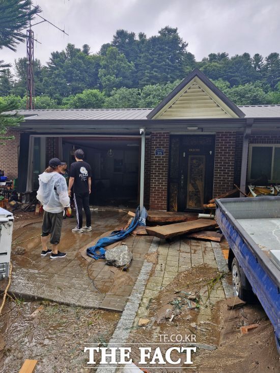 지난 16일부터 20일 새벽까지 내린 극한호우로 망가진 집 내부를 쳐다보는 경기 가평군 조종면 주민들이 망연자실한 채로 우두커니 서 있다./가평군
