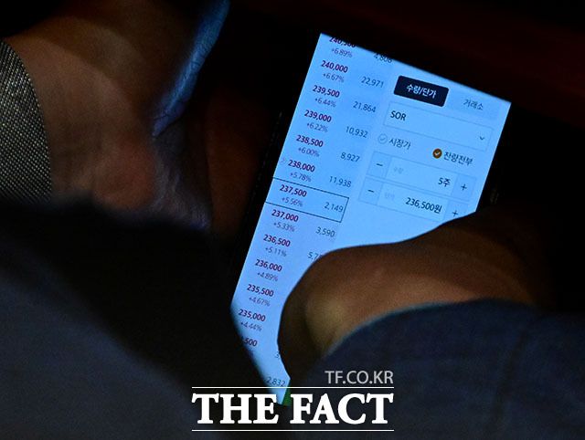 <더팩트>는 지난 4일 이 의원이 국회 본회의 도중 타인 명의의 주식 계좌로 네이버 등 종목을 실시간 거래하는 모습을 포착해 5일 단독 보도했다. 이 4일 서울 여의도 국회에서 열린 본회의에서 타인 명의로 개설된 주식 계좌를 확인하고 있다. /남윤호 기자