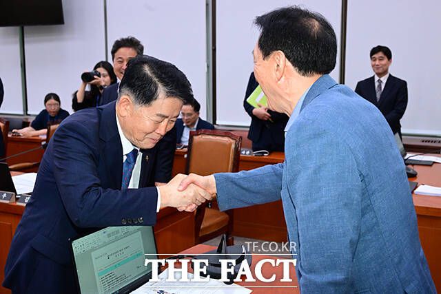 전체회의를 마친 후 김경협 청장과 인사하는 김석기 국회 외통위원장(오른쪽).