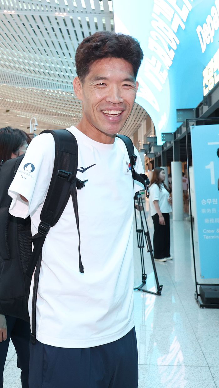 트라이애슬론 대표팀 김황태가 21일 인천국제공항을 통해 2024 파리 패럴림픽 출전을 위해 출국하며 밝은 표정으로 인사하고 있다. 사진 | 인천국제공항=연합뉴스